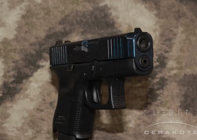Glock 26 with custom Cerakote finish in Socom Blue and sparkly Cerakote FX Liberty